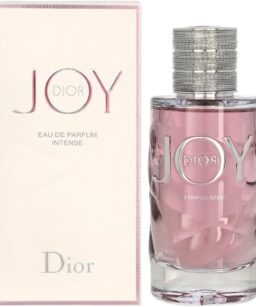 Dior Joy perfume bottle with pink liquid and silver cap, displayed next to its box.
